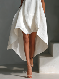 Robe midi sans manches blanche, bas drapé ample et effet superposé