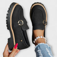 Mocassins Aurora noirs, boucle ovale métallique et semelle beige contrastée