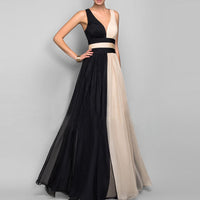 Robe longue noire avec panneau nude sur la jupe, décolleté V, taille ceinturée.