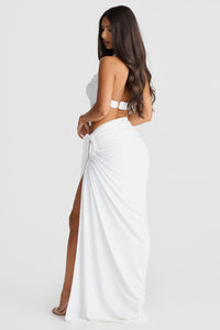 Robe longue blanche vue de profil, bretelles, drapé sur le côté et fente jusqu’au genou