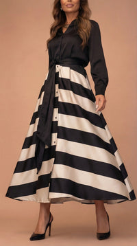 Robe noire à nœud à la taille, jupe évasée à rayures blanc et noir.