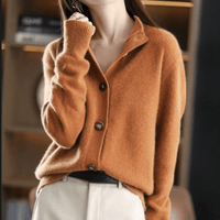 Gilet en cachemire orange à col chemise, manches longues, boutons ronds en nacre.
