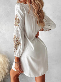 Robe midi blanche bohème vue de dos, manches bouffantes et broderies dorées