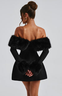 Robe courte noire vue dos, épaules dénudées avec fausse fourrure sur le haut et la taille.